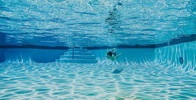 A child swimming in a residential pool.
