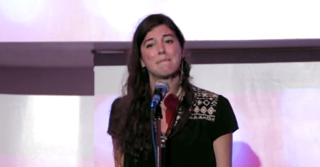 Woman standing before a microphone