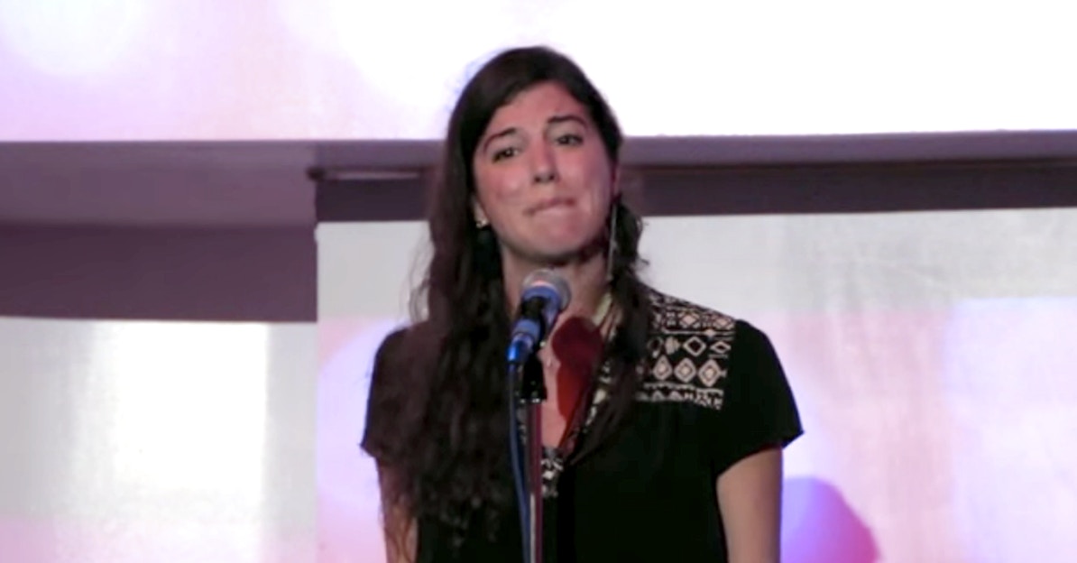 Woman standing before a microphone