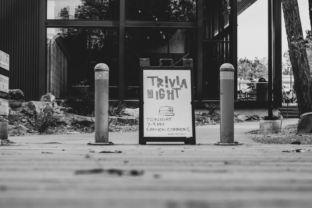 A black and white sign outside a building that says "Trivia Night"
