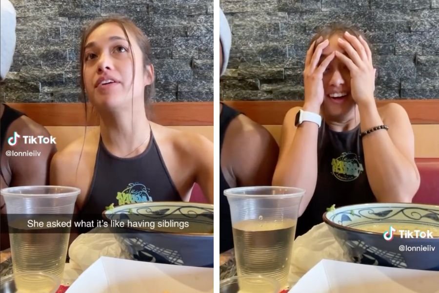 Young woman sitting in booth; Young woman laughing and covering her head with her hands