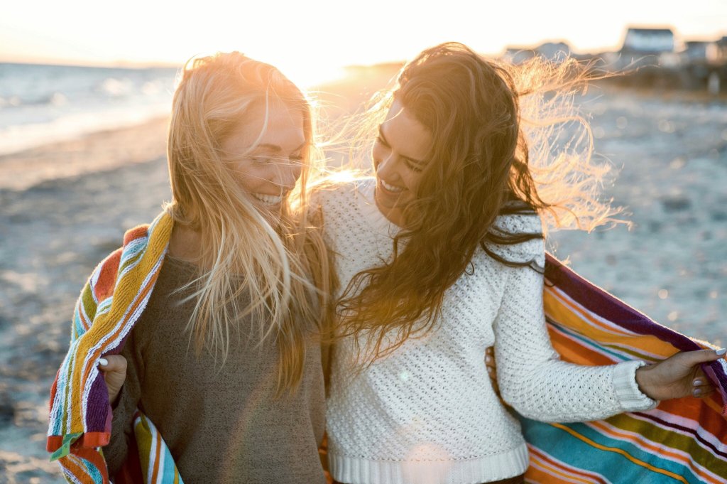 two women walking on the beach