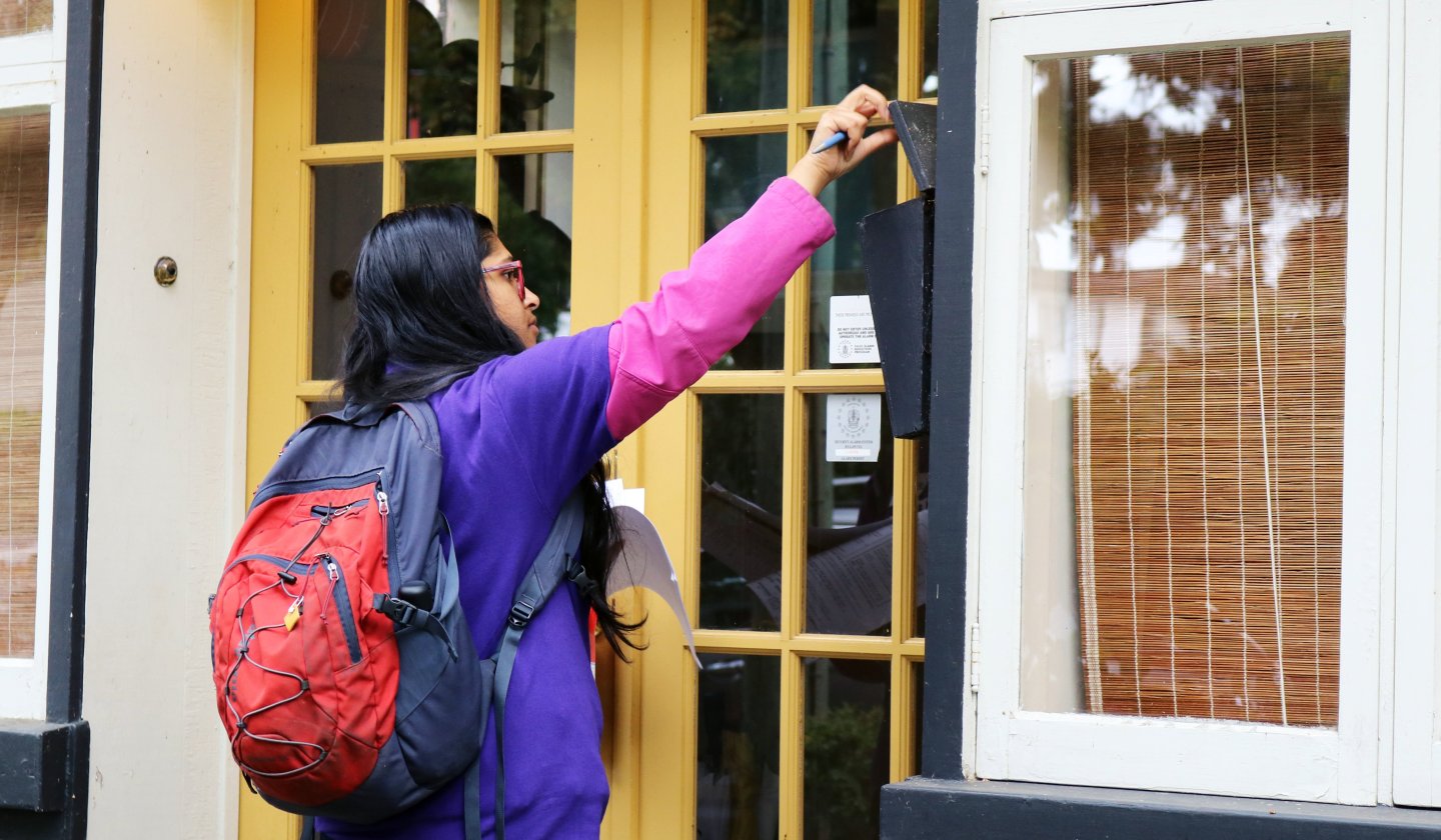 woman opens mailbox