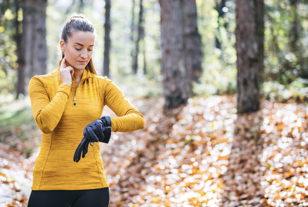 Woman checking her heart rate outside.