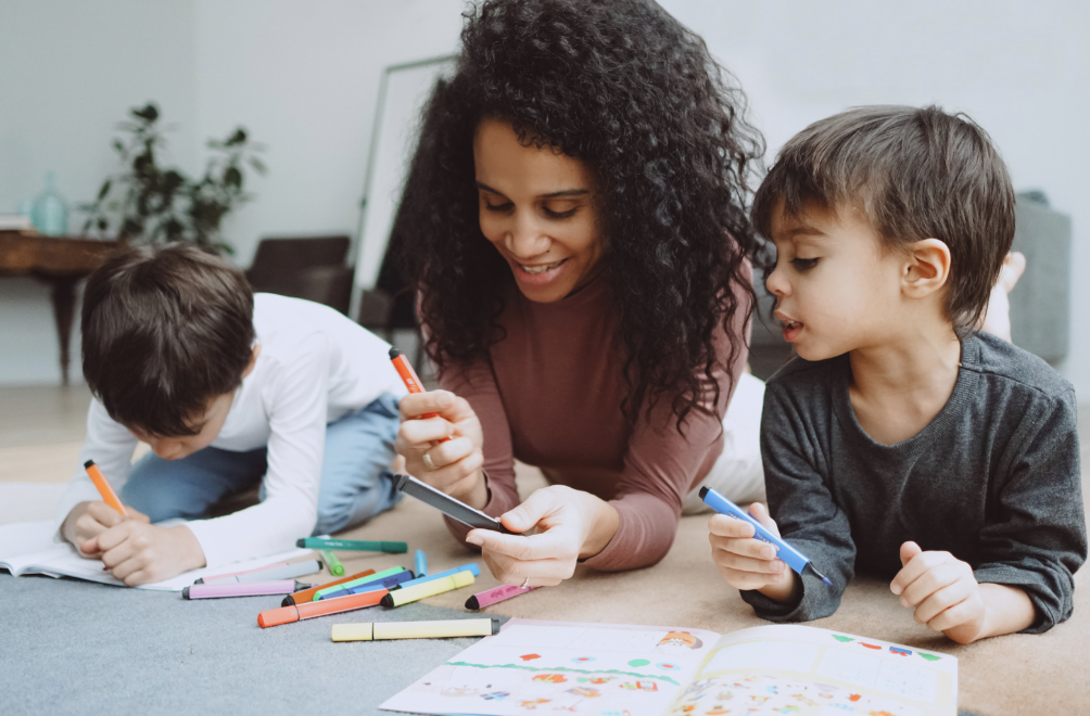 Woman coloring with two boys