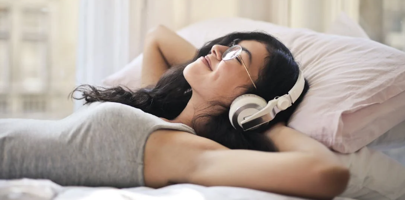 listening to music, learning a skill, woman in bed