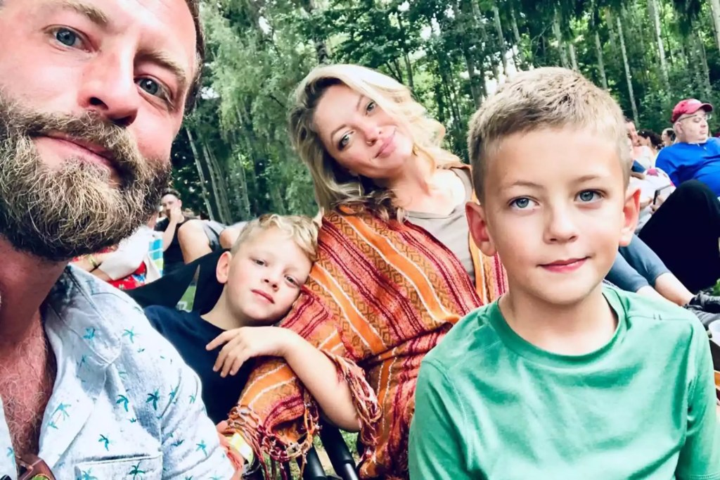 Young family takes a photo outside