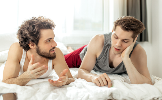 Gay men having a conversation in bed