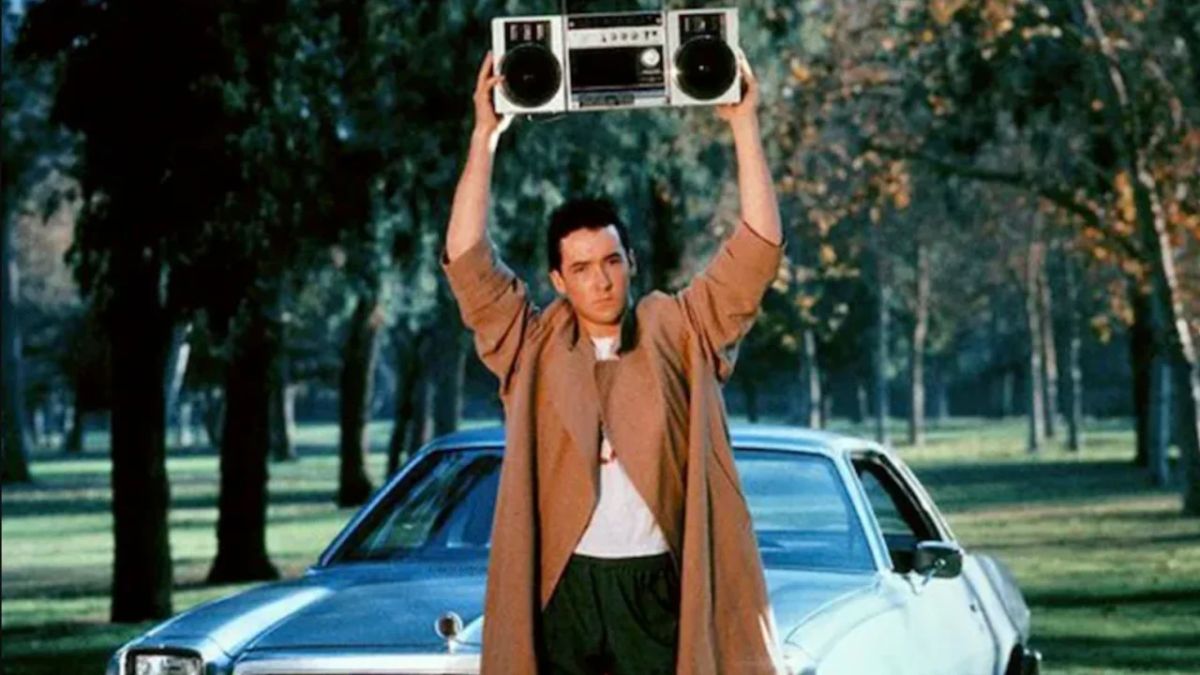 John Cusack holding a boombox over his head in