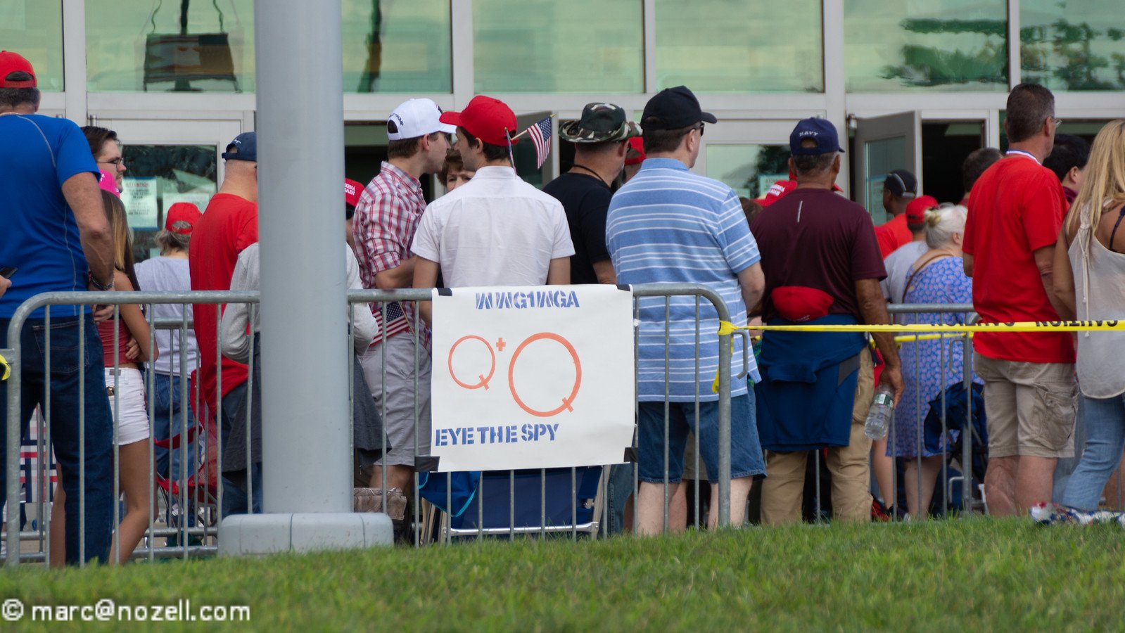 A group of people belonging to a Qanon splinter group stand in a line