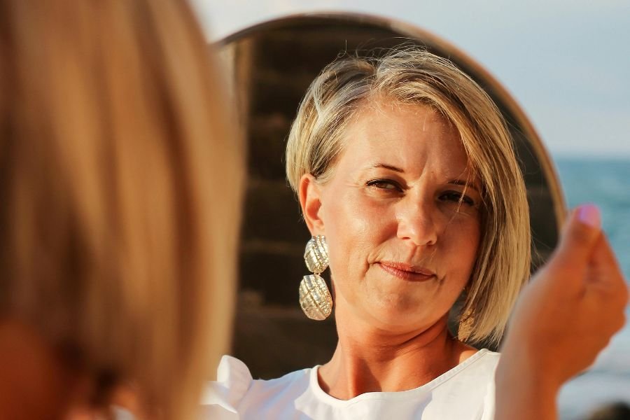 middle-aged woman looking in the mirror