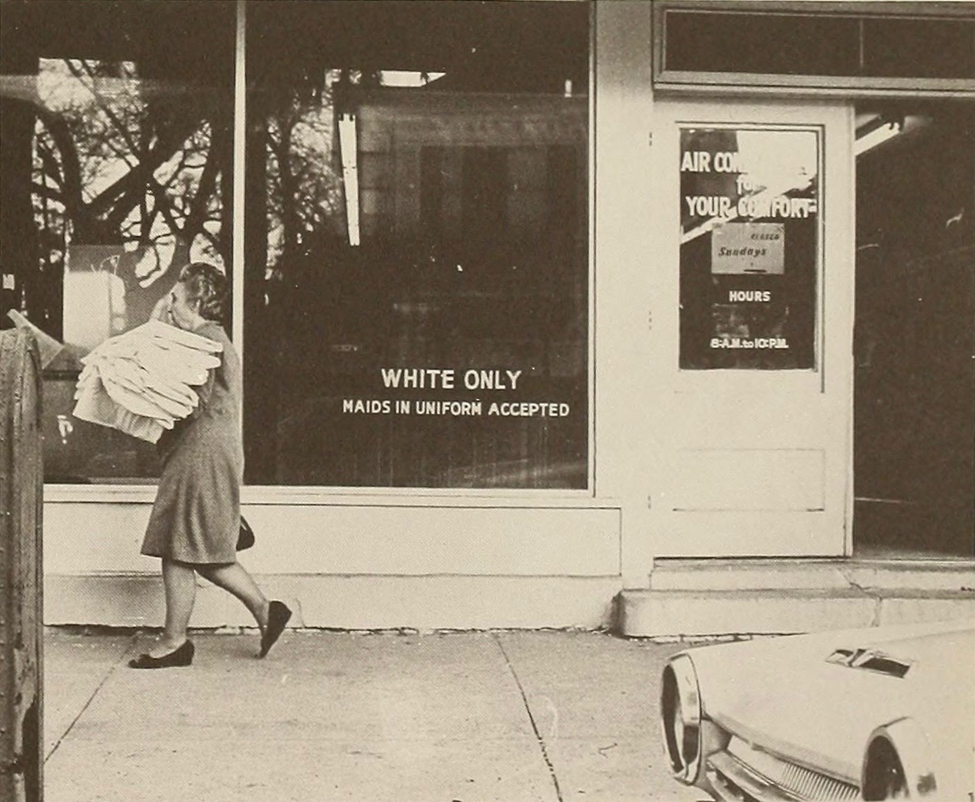 black and white photo of a storefront that reads 