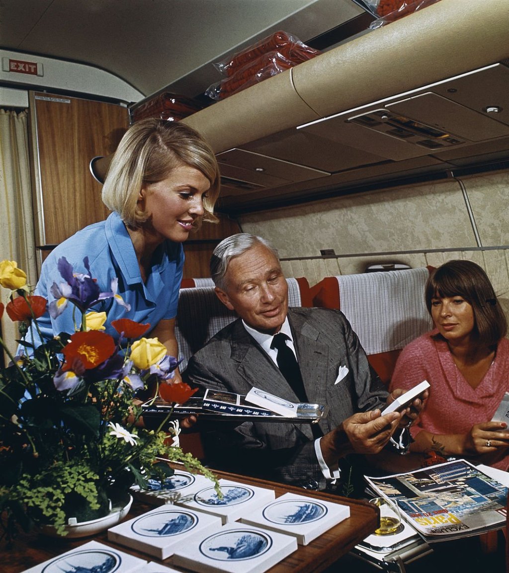 stewardess attends to passengers on vintage airline