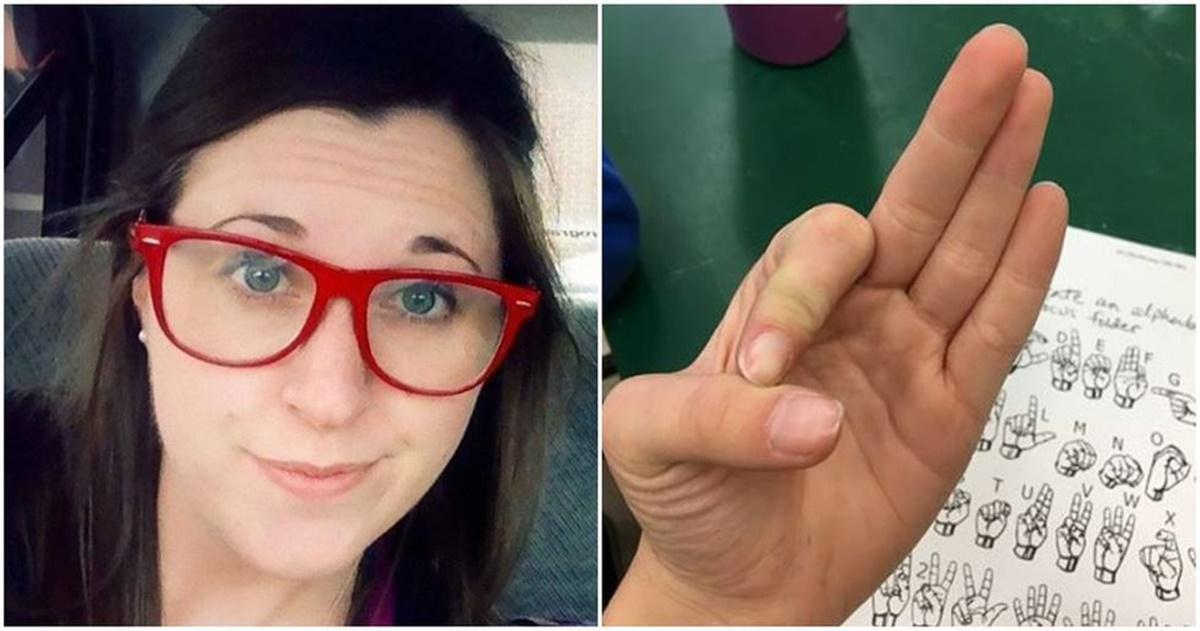 woman in red glasses; ASL sign for "OK"