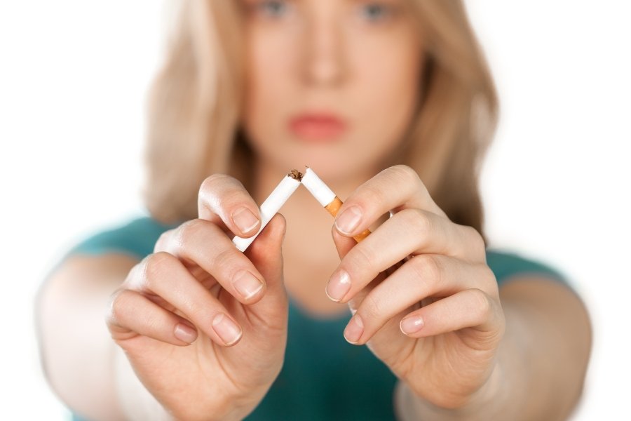 woman breaking a cigarette in half