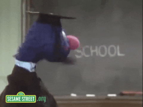 gif of Grover from Sesame Street in a cap in gown reading a blackboard that says