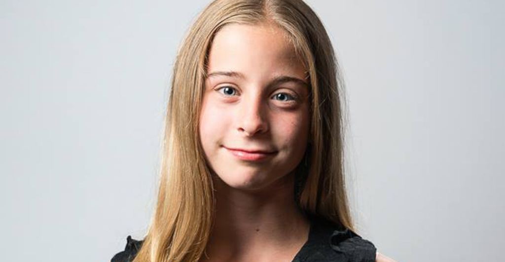 young blond girl smiles