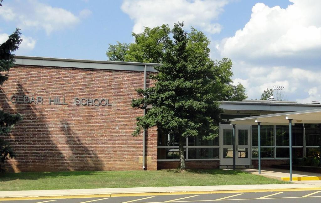 brick building with "Cedar Hill School" written on the side