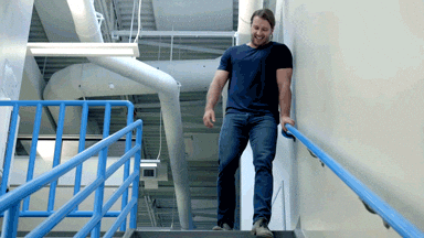 gif of man running up the stairs while another walks downstairs slowly and painfully