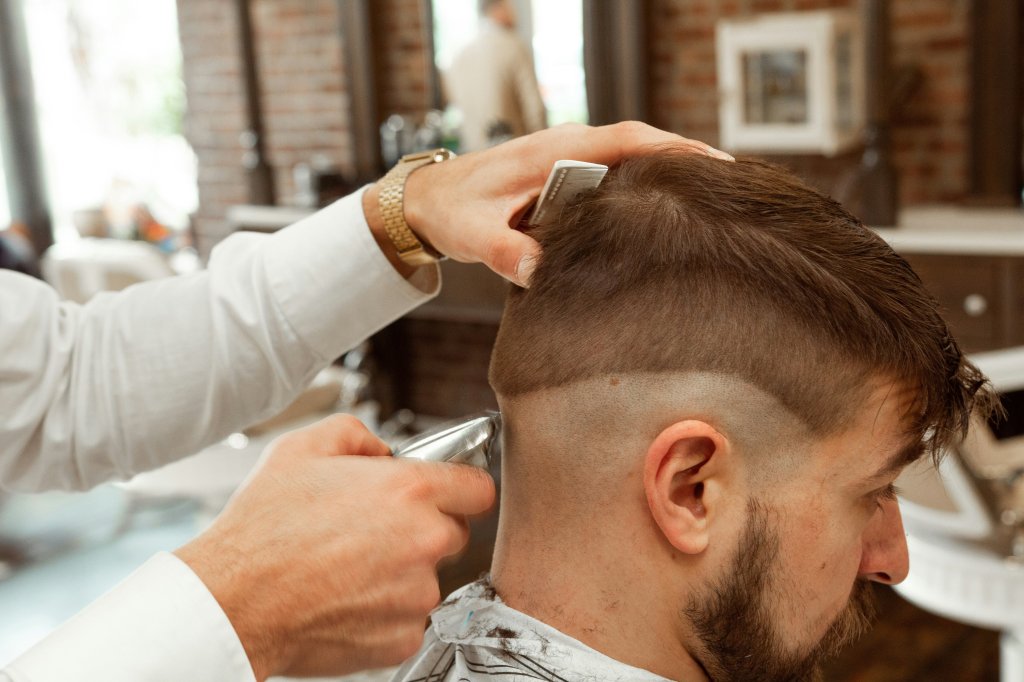 man getting haircut in barbershop