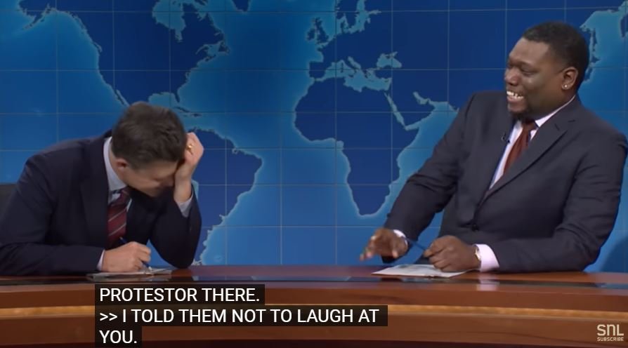 Colin Jost and Michael Che laughing on Weekend Update
