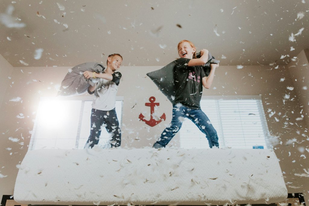two boys having pillow fight