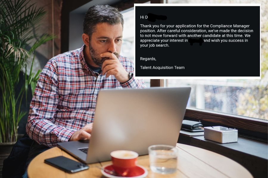 man on a computer at a coffee shop with an email message in the top right corner