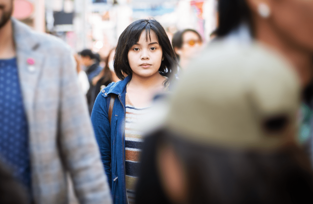 Woman alone in a crowd