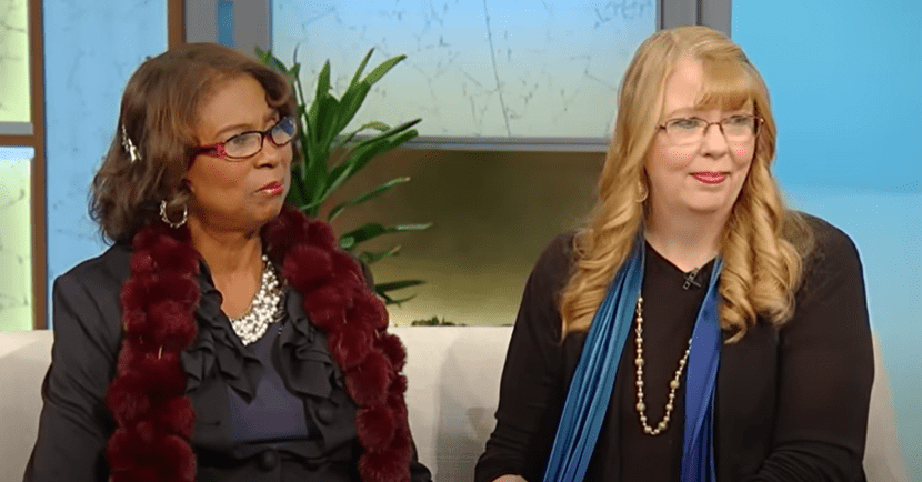 two women sitting on a couch at a talk show