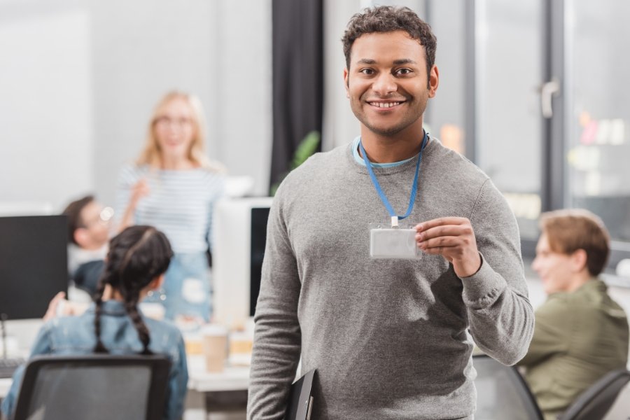 man holding up a name tag