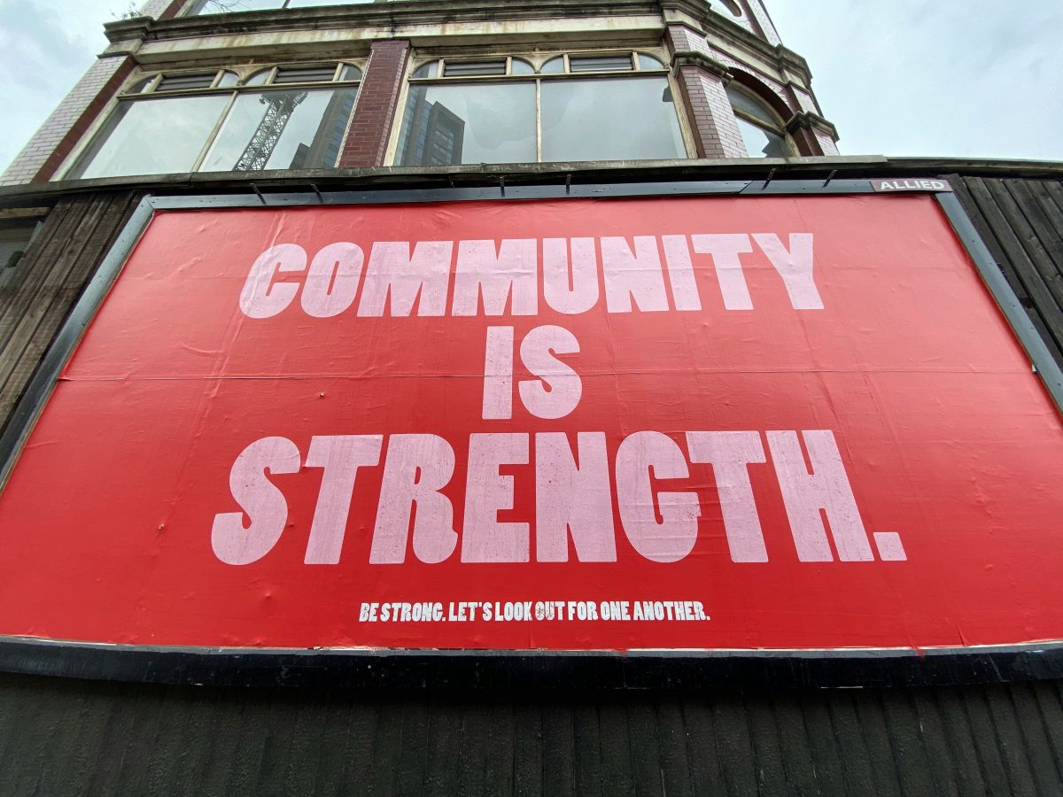 red and white sign that reads, Community