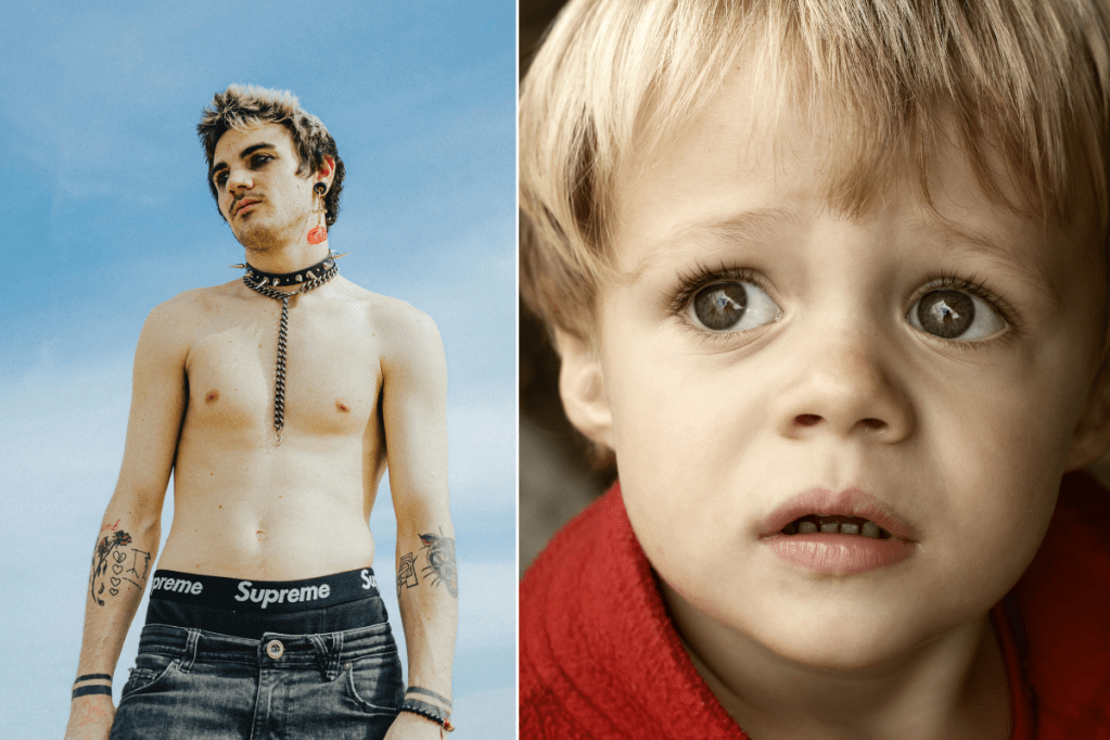young shirtless "goth" man with eye makeup, tattoos, a spiked collar, plugs, and frosted hair; a little boy looking sad