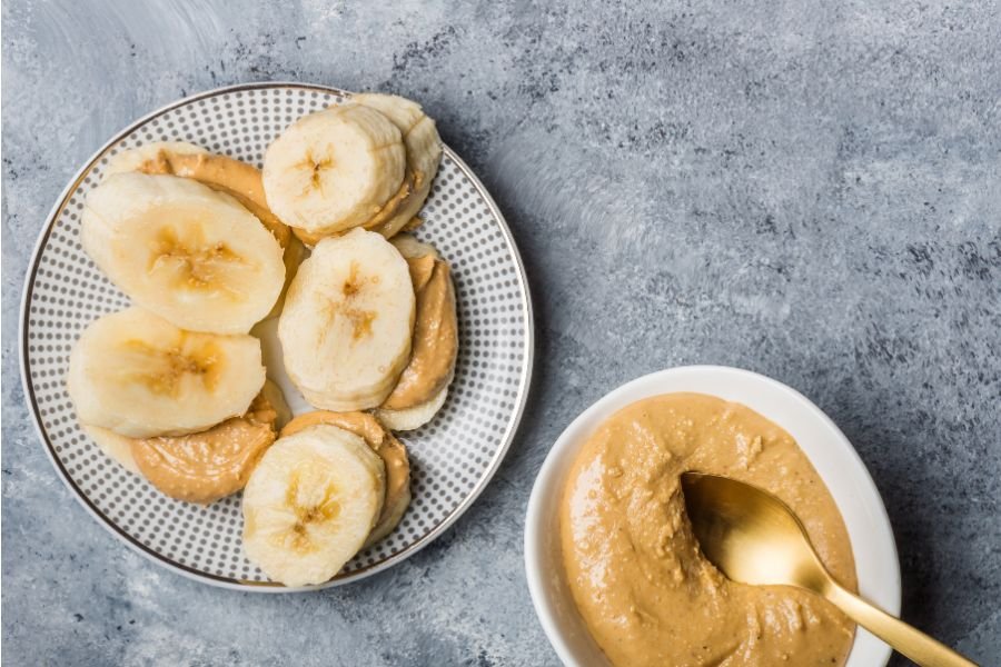 banana slices and peanut butter beside a dish of peanut butter