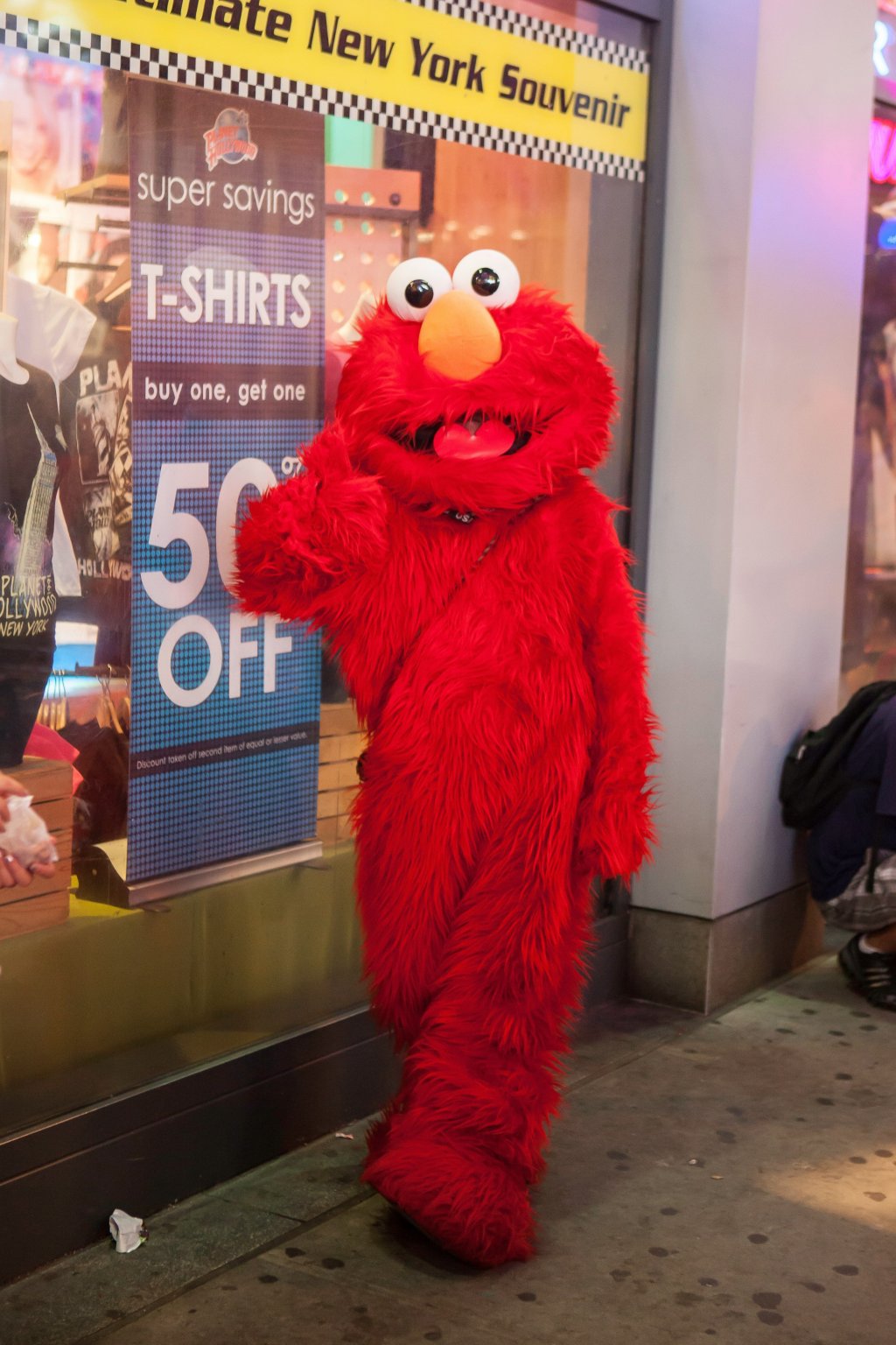 person dressed as Elmo poses for a photo