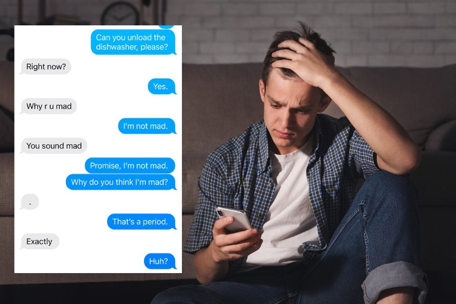 young man looking at his phone with a worried expression