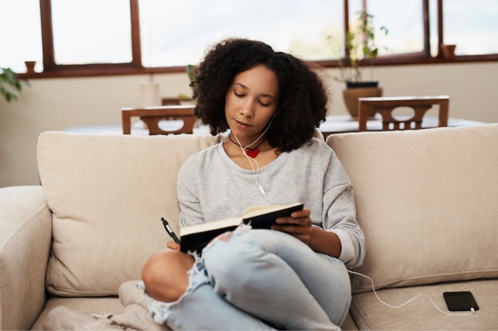 woman writing in a journal, gratitude journal, contributions journal, adam grant