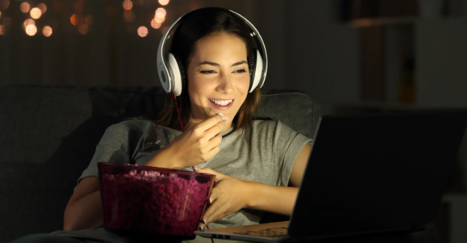 woman, laptop at night, popcorn, woman smiling laptop, late night snack, 