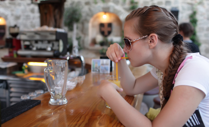 teen girl drinking, orange juice, screwdriver, bar, alcoholism