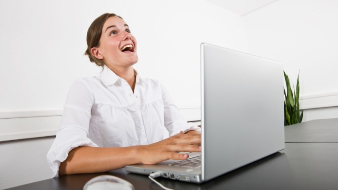 woman laughing, laughing at computer, online dating, blonde woman, young woman