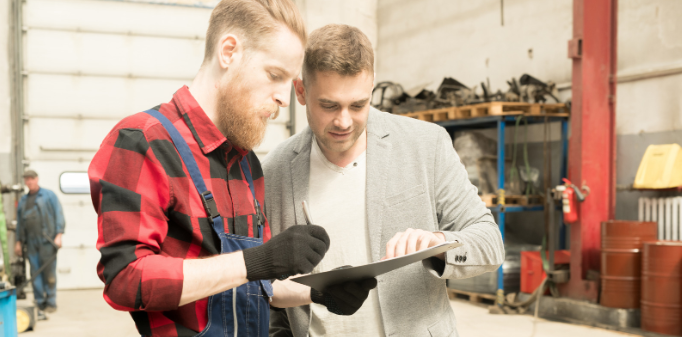 laborer, blue collr guy, metal shop, signing, two men talking
