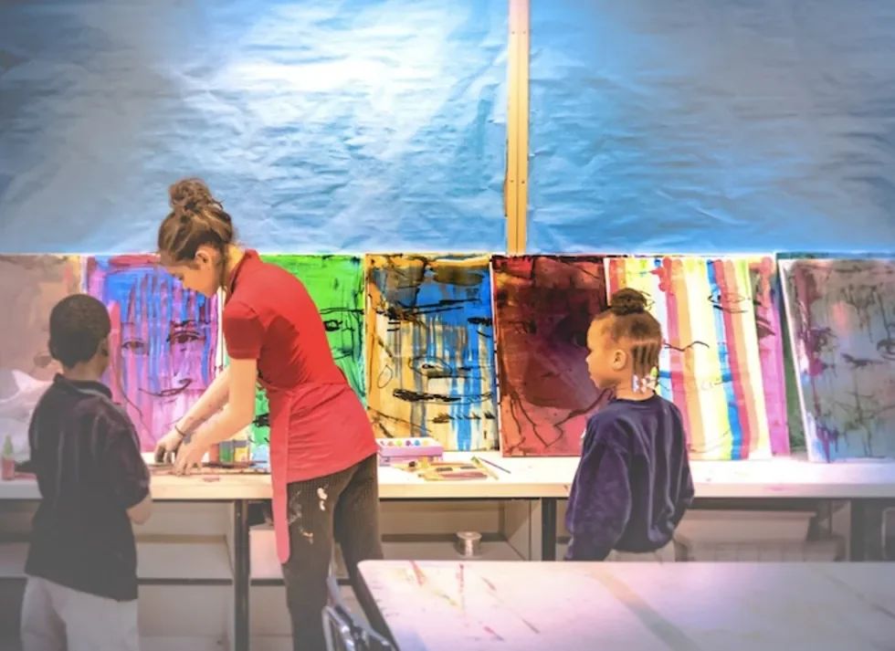 painting colorful abstract art on canvases.