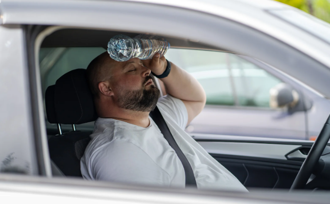 hot car, cool car, man with fan, summer car, summer heat, sweating,