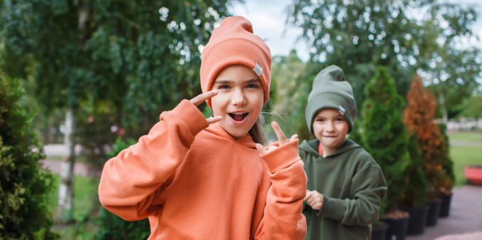 girl hoodie, young girl sweatshirt, girl in orange, young sassy girl, hand signals 