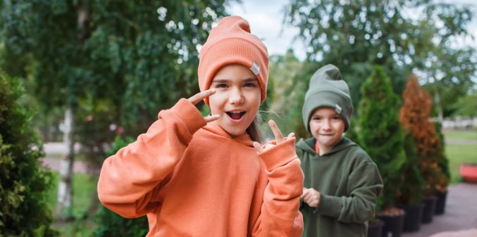 girl hoodie, young girl sweatshirt, girl in orange, young sassy girl, hand signals