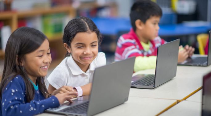 children, children and computers, laptops, smiling girls, classroom, two girls and a laptop,