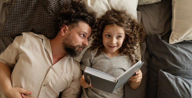 dad, dad and daughter, story time, parent in bed, happy girl, bonding