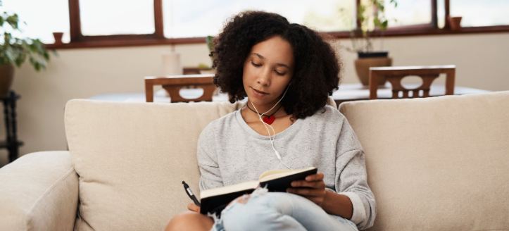 notes, writing notes, headphones, woman on couch, 