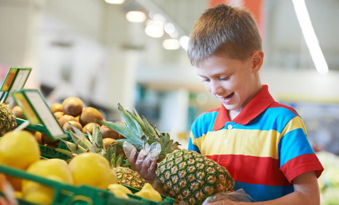 kid shopping, independant kid, boy, boy with pineapple, boy in grocery store