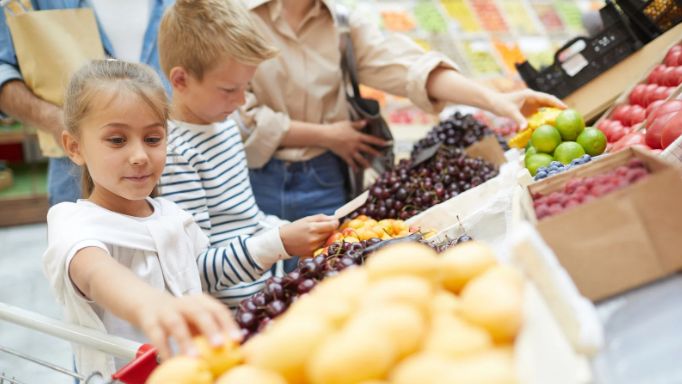 boy and girl, supermarket, fruit, cherries, limes, grapes