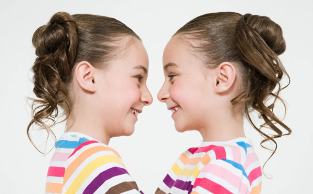 twins, twin girls, young girls, twins dressed alike, smiling twin girls, 6-year-old girls